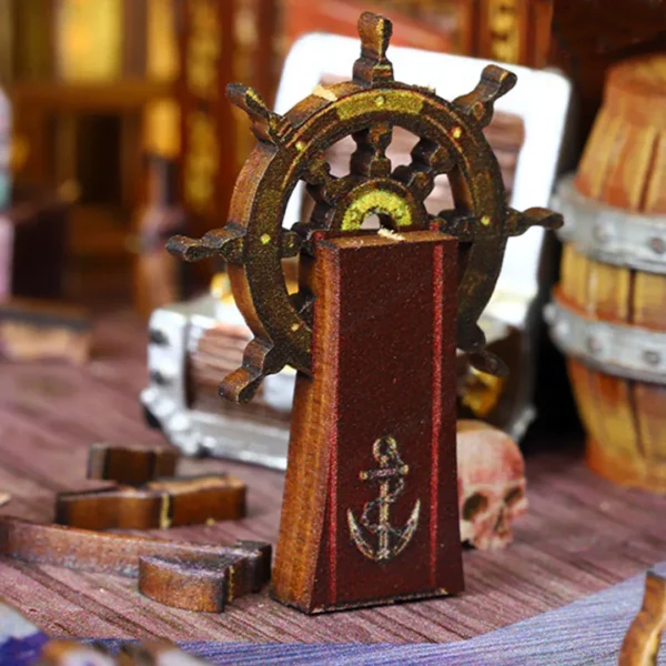 Close-up view of the captain’s steering wheel in The Pirate Ship Aden DIY Book Nook kit, featuring intricate details and nautical symbols.