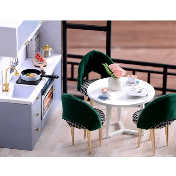 lose-up view of a modern miniature dining room with velvet chairs, a marble-style table, and a small kitchen setup featuring a frying pan and utensils.