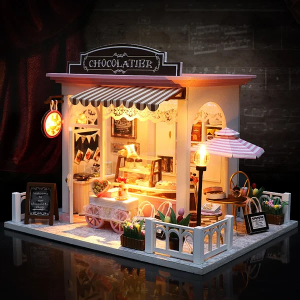 A nighttime view of the Cocoa Fantasy Chocolate Shop, warmly lit with a glowing sign and inviting interior lights, showcasing a charming and cozy dessert store.