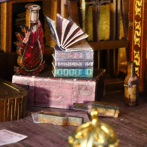 Close-up of miniature books and a lamp on The Pirate Ship Aden DIY book nook, showing detailed craftsmanship and vintage design elements.