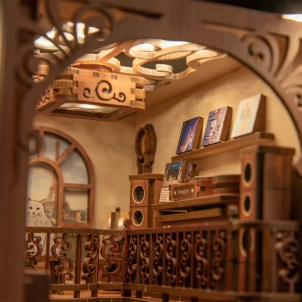 Close-up of the upper floor in The Secret Rhythm book nook, featuring detailed wooden railings, vinyl records, vintage speakers, and cozy lighting.