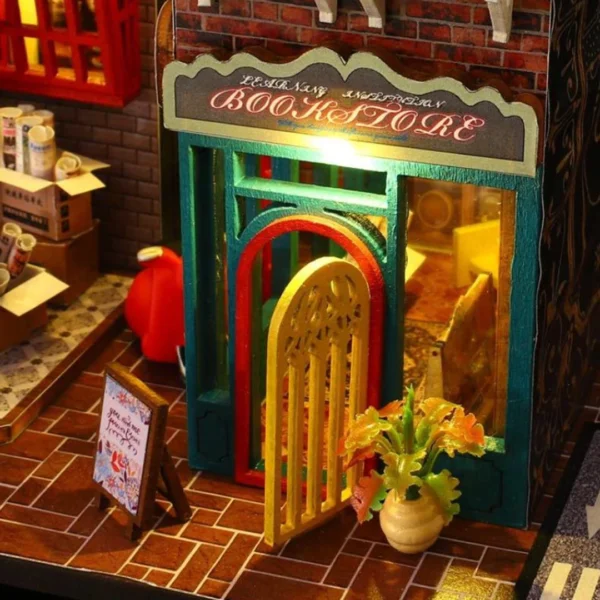 Close-up of the vintage bookstore entrance with an arched door, decorative sign, and potted plant, part of the Scarbrough Hotel DIY miniature dollhouse kit.