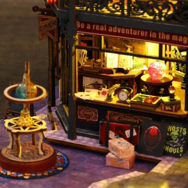 Close-up of the magic shopfront in the Holo Magic City DIY miniature dollhouse, featuring crystals, spell books, a glowing orb, and other mystical artifacts.