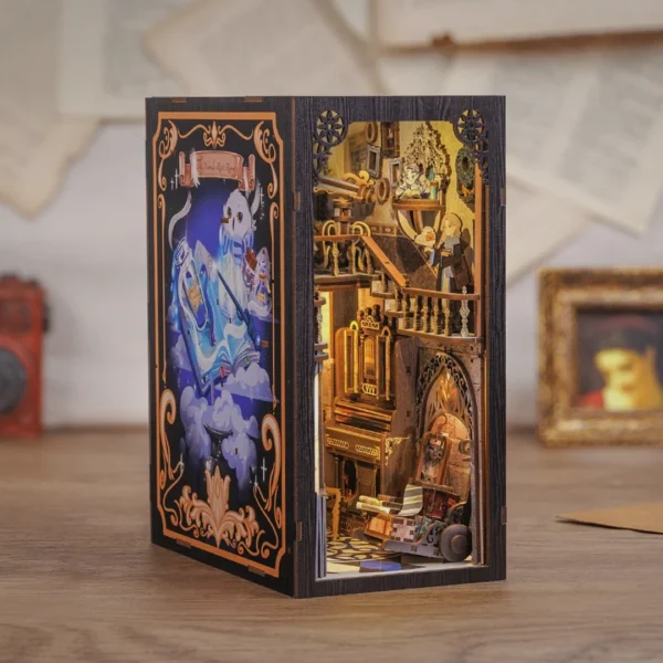 Image showing the intricate interior of the Nebula Rest Room DIY book nook, featuring a magical organ, a study desk, and a young apprentice holding a magical book.