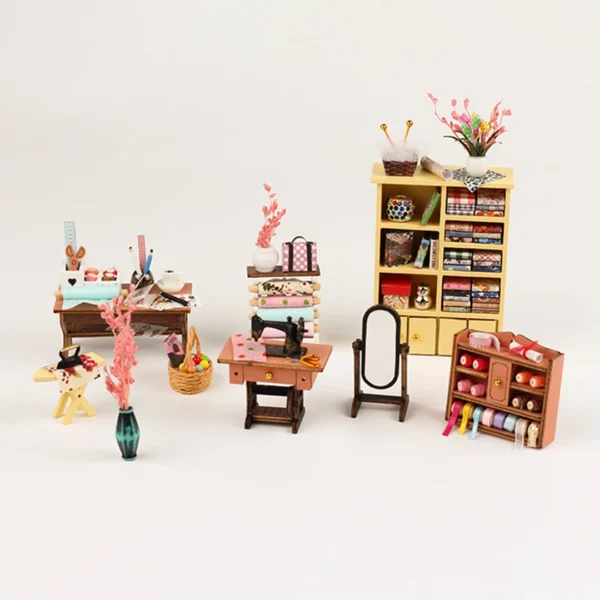 A selection of miniature furniture pieces in Tailor Shop diy miniature dollhouse kit, including a sewing machine table, fabric shelves, workbenches, a full-length mirror, and decorative items like vases and baskets.