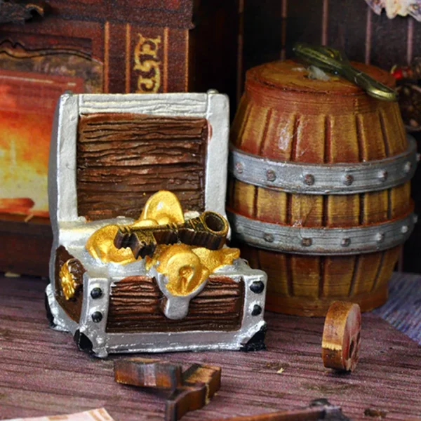 Close-up of a treasure chest filled with gold coins in the pirate captain's cabin on The Pirate Ship Aden DIY book nook.