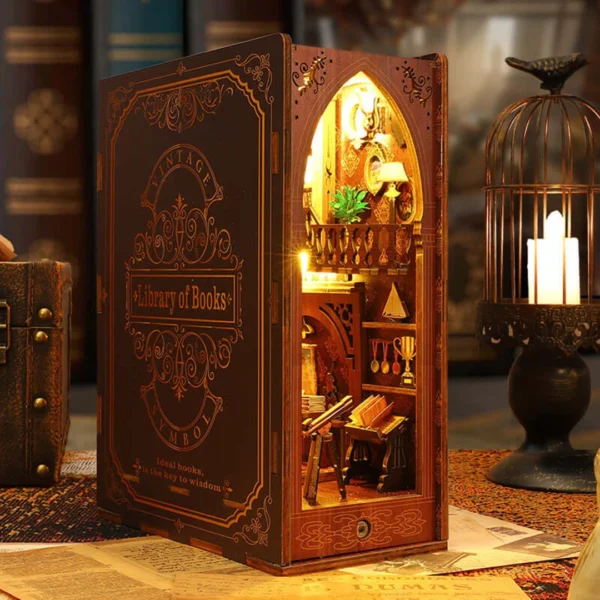 A beautifully crafted DIY Book Nook Shelf Insert titled "Library of Books," featuring a vintage two-story library with warm LED lights, bookshelves, paintings, a fireplace, an astronomical telescope, and other intricate details.