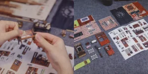 Hands assembling delicate parts of the Rose Detective Agency book nook, featuring miniature brick walls, furniture, and detailed components.