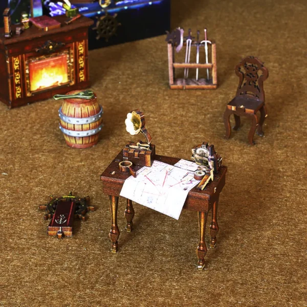 Selected miniature pirate furniture in The Pirate Ship Aden DIY book nook including a captain’s table with a sea chart, a wooden barrel, a fireplace, a chair, and a sword rack.