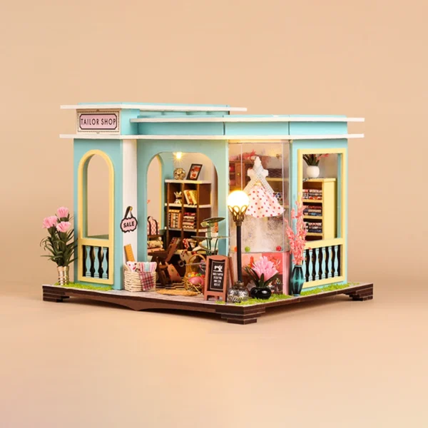 Tailor Shop DIY miniature kit displayed against a warm background with soft lighting, highlighting the shop's detailed exterior and inviting atmosphere.