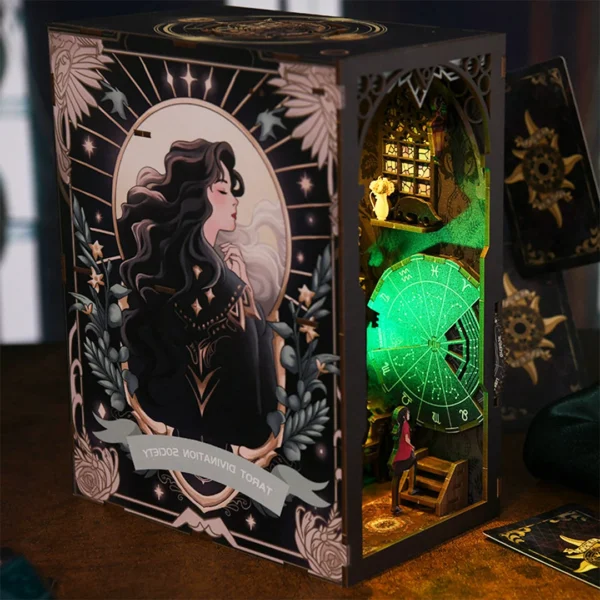 Left side view of Tarot Divination Society book nook, featuring an elegant young lady painting on the exterior and a glimpse of the illuminated mystical interior.