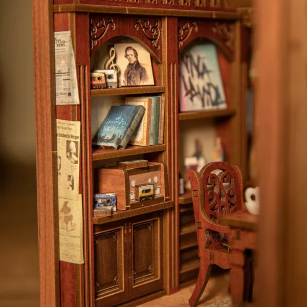 Close-up view of The Secret Rhythm book nook, featuring a bookcase with classic books, vintage radios, song tapes, and a portrait of a musical legend.